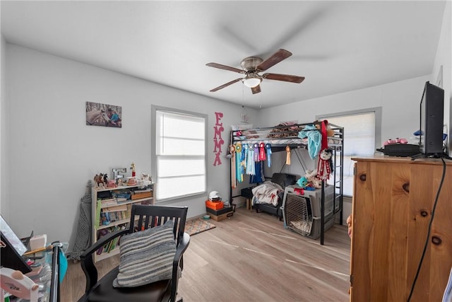 bedroom featuring light wood-style flooring and ceiling fan