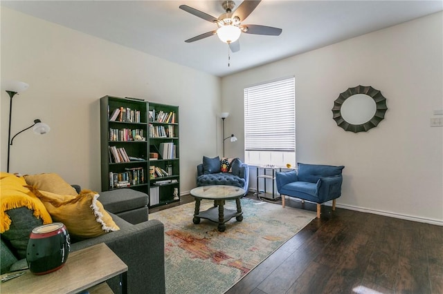 sitting room featuring baseboards, a ceiling fan, and hardwood / wood-style flooring