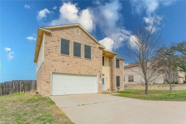 view of front of property featuring brick siding, driveway, a front lawn, and fence