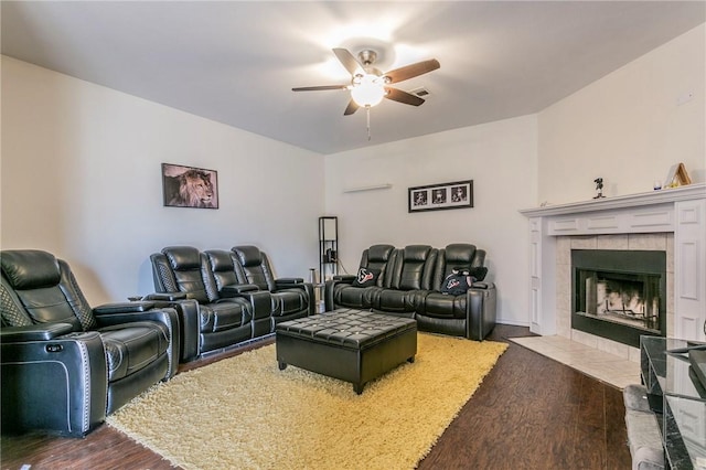 home theater room featuring visible vents, a tile fireplace, a ceiling fan, and dark wood-style flooring