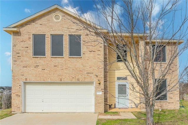 view of front facade with brick siding, an attached garage, and driveway