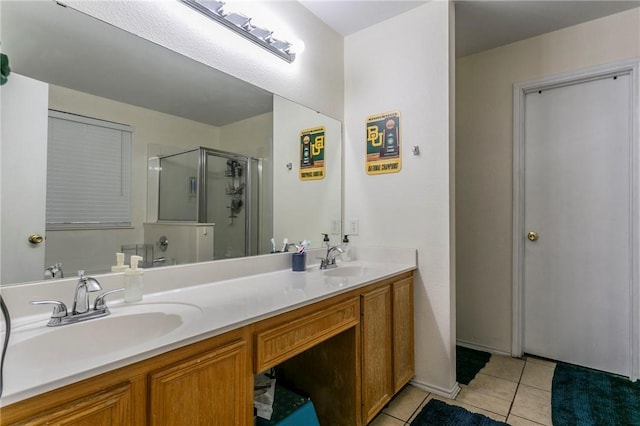 full bath featuring tile patterned floors, a shower stall, double vanity, and a sink