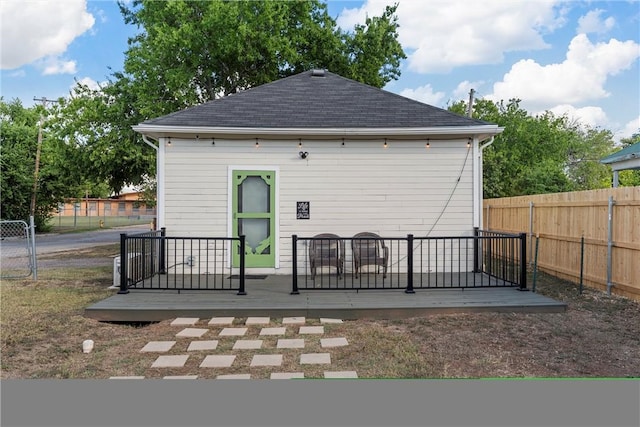 back of house with a wooden deck