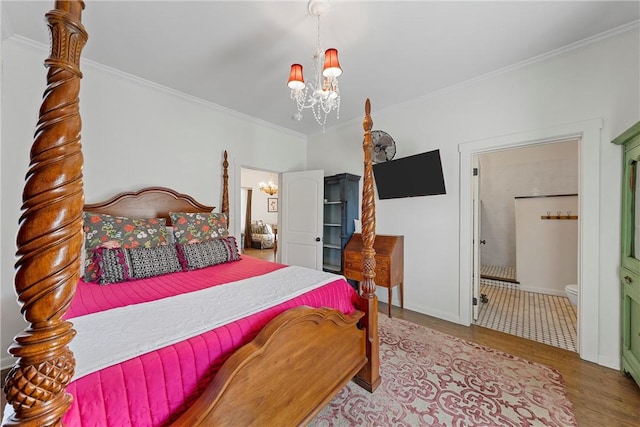 bedroom featuring a chandelier, connected bathroom, light hardwood / wood-style flooring, and crown molding