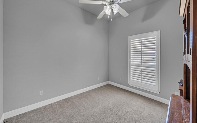 carpeted spare room with ceiling fan