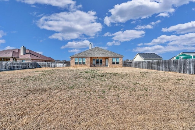 rear view of house with a yard