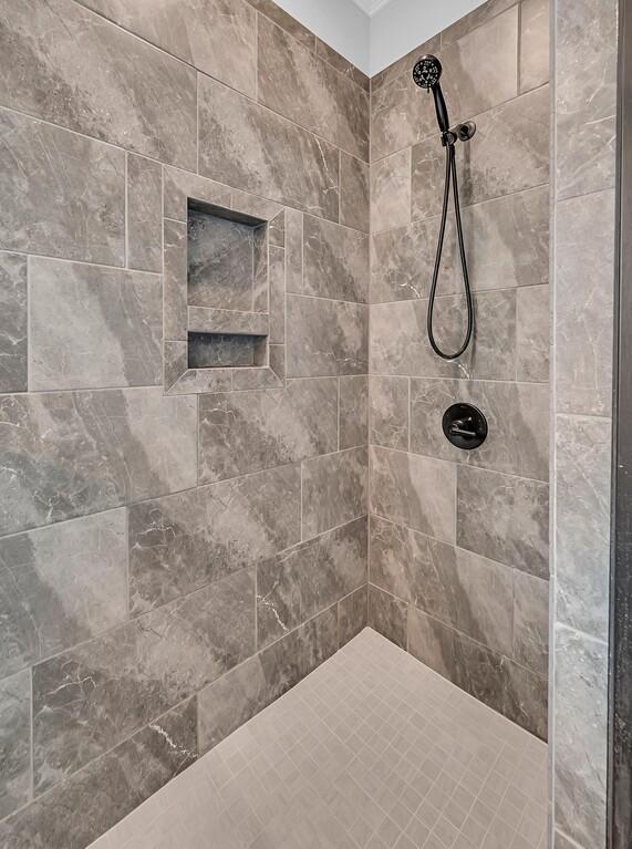 bathroom with tiled shower