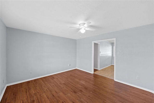 empty room featuring ceiling fan and wood-type flooring