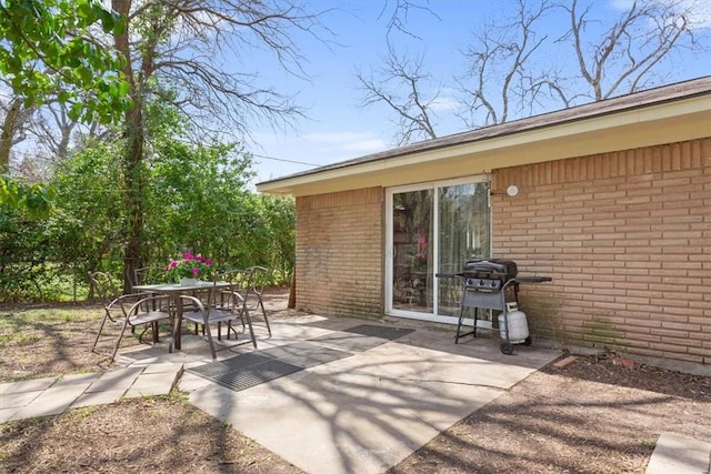 view of patio with outdoor dining space and a grill