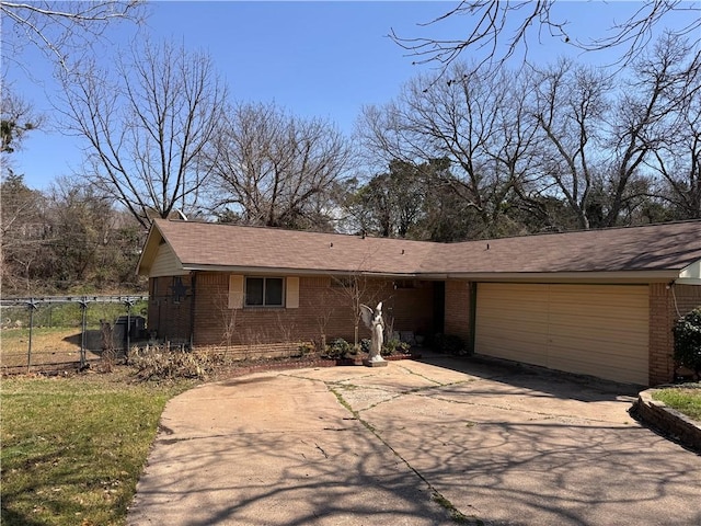 view of front facade with brick siding, driveway, a garage, and fence