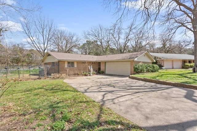 view of front of home featuring fence, concrete driveway, a front yard, an attached garage, and brick siding