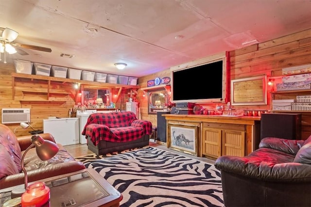 living room with visible vents, wood walls, and a wall mounted AC