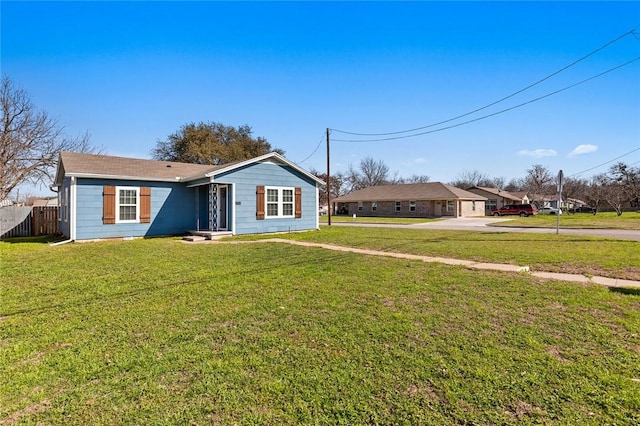 view of front of home with a front lawn and fence