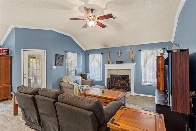 living room featuring a textured ceiling, vaulted ceiling, ceiling fan, and a healthy amount of sunlight