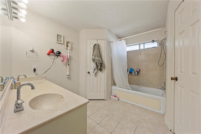 bathroom with tile patterned floors, shower / bath combo, a textured ceiling, and vanity