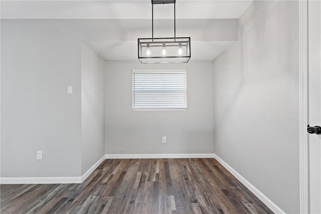 unfurnished room with wood finished floors and baseboards