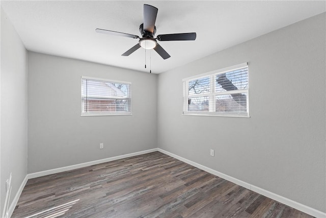 spare room with ceiling fan, baseboards, and wood finished floors