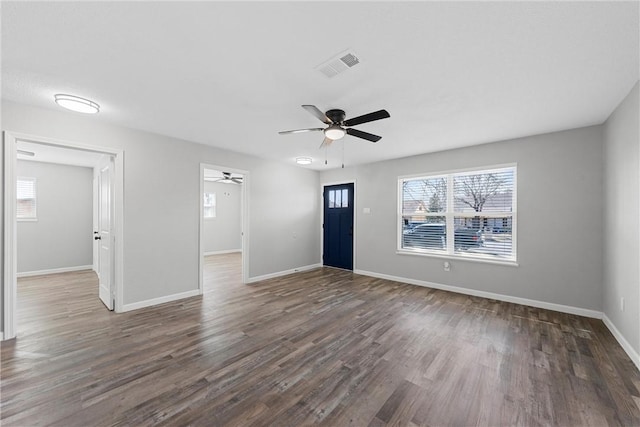 unfurnished living room featuring ceiling fan, wood finished floors, visible vents, and baseboards