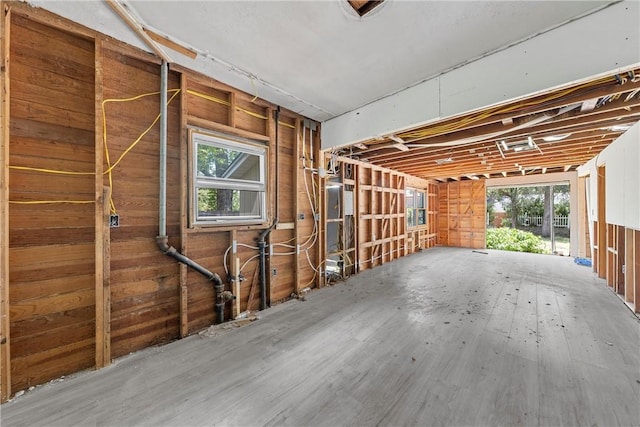 misc room with hardwood / wood-style floors, plenty of natural light, and wooden walls