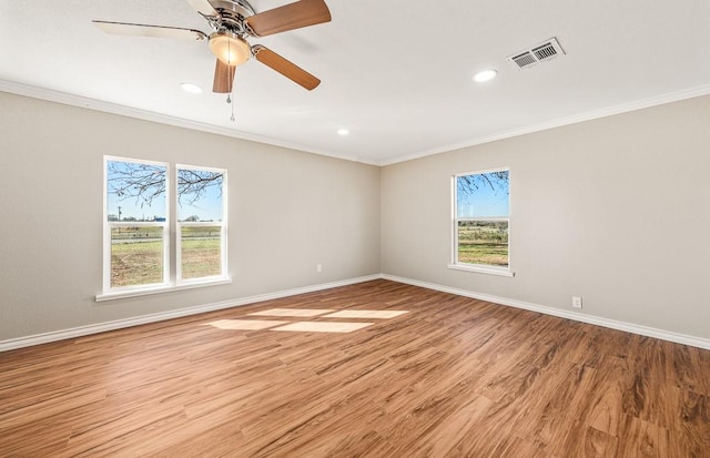 empty room featuring light wood-type flooring, ceiling fan, and ornamental molding