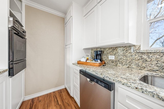 kitchen with light stone countertops, white cabinetry, dark hardwood / wood-style flooring, stainless steel dishwasher, and oven