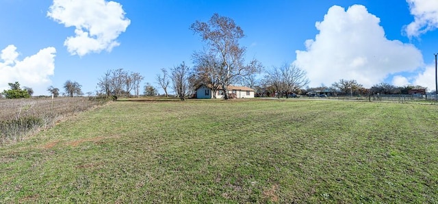 view of yard featuring a rural view and fence