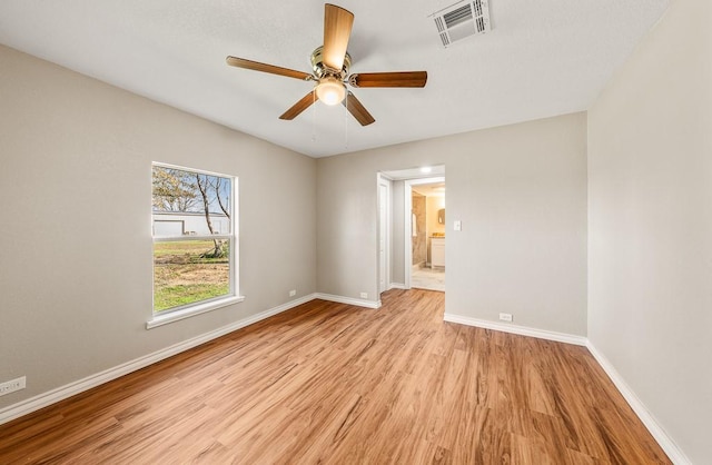 empty room with light hardwood / wood-style flooring and ceiling fan