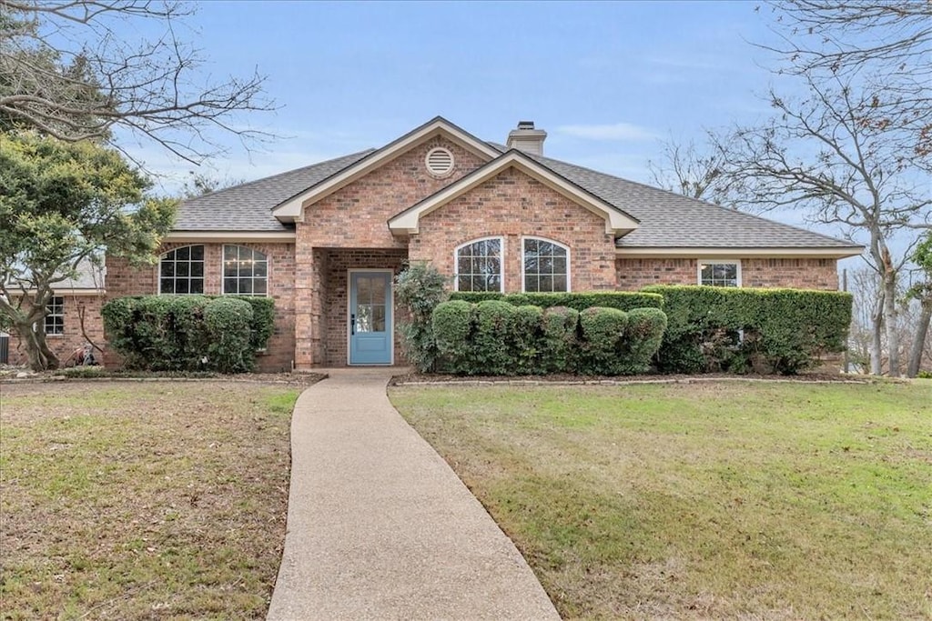 ranch-style home with a front yard