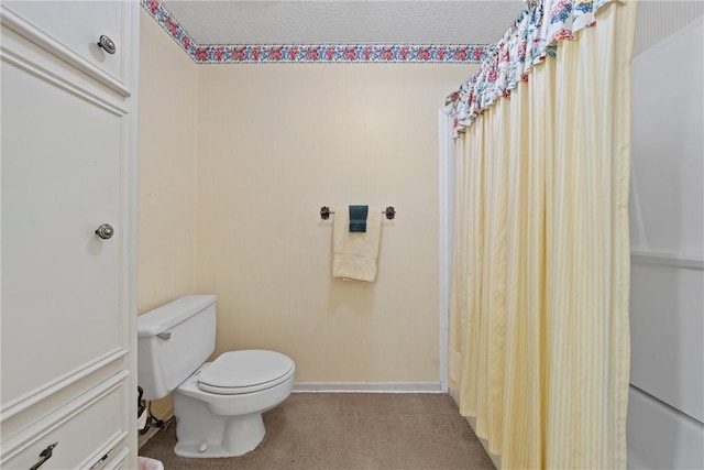 bathroom featuring toilet and a textured ceiling