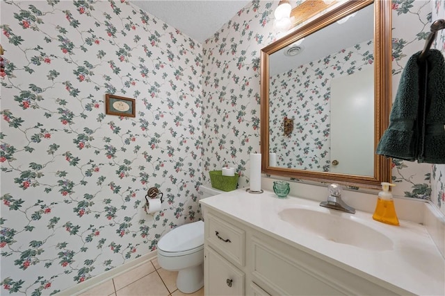 bathroom featuring vanity, tile patterned floors, and toilet