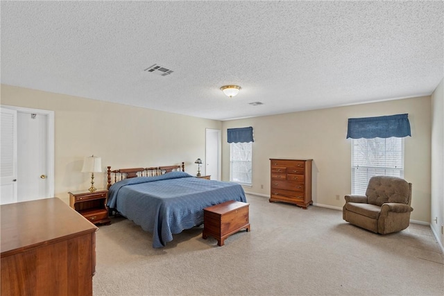 carpeted bedroom featuring a textured ceiling