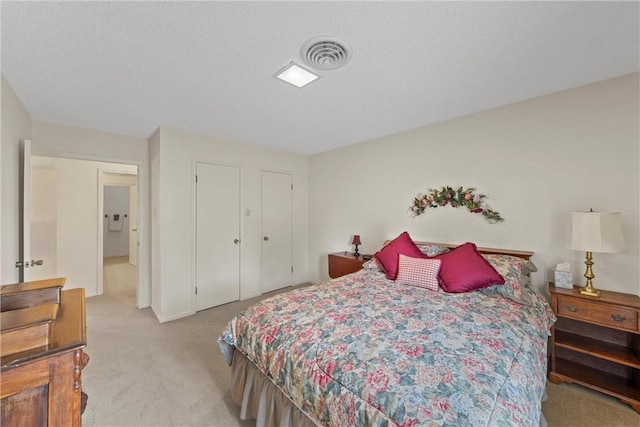 carpeted bedroom featuring a textured ceiling and a closet