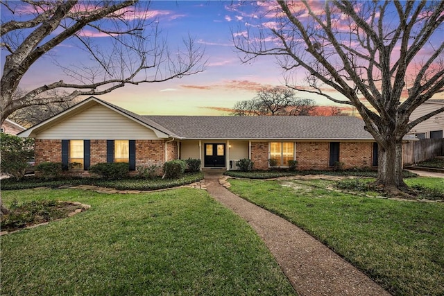 ranch-style home with a yard