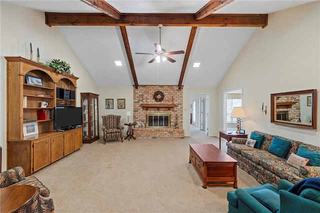 carpeted living room with a brick fireplace, beamed ceiling, high vaulted ceiling, and ceiling fan