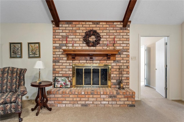 living room with a textured ceiling, a fireplace, beamed ceiling, and carpet