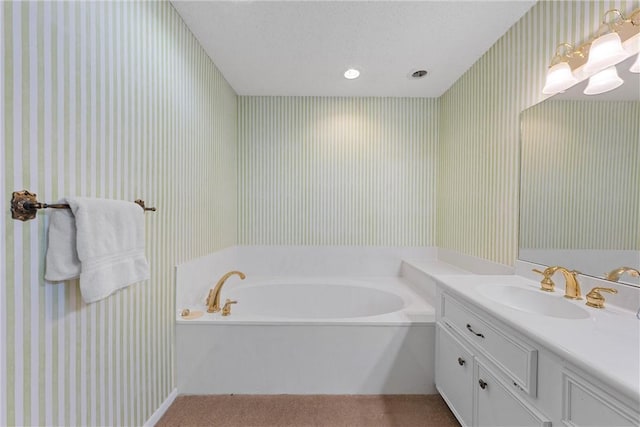 bathroom featuring vanity and a bath