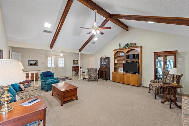 carpeted living room featuring ceiling fan, high vaulted ceiling, beam ceiling, and french doors