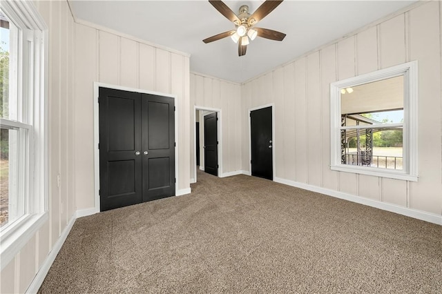 unfurnished bedroom with ceiling fan, a closet, and carpet floors