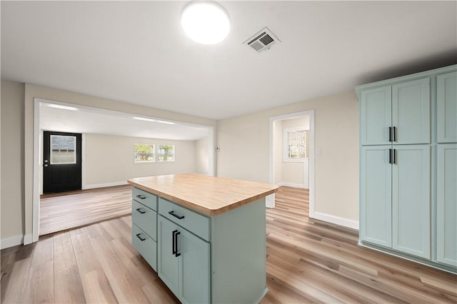 kitchen featuring light hardwood / wood-style floors, a kitchen island, and butcher block countertops