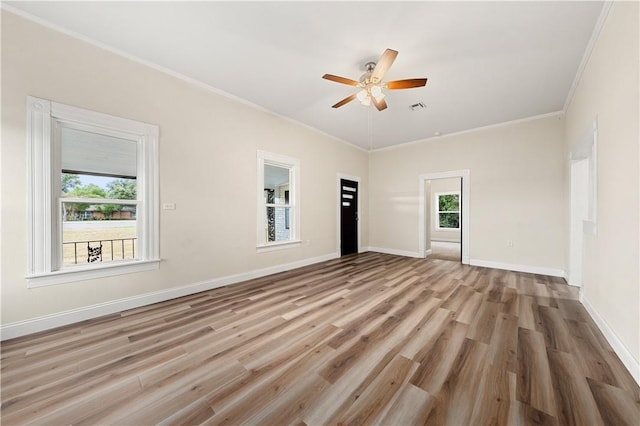 empty room with ceiling fan, a healthy amount of sunlight, light wood-type flooring, and ornamental molding