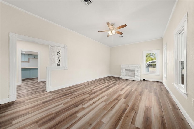 unfurnished living room featuring ceiling fan, light hardwood / wood-style floors, and crown molding