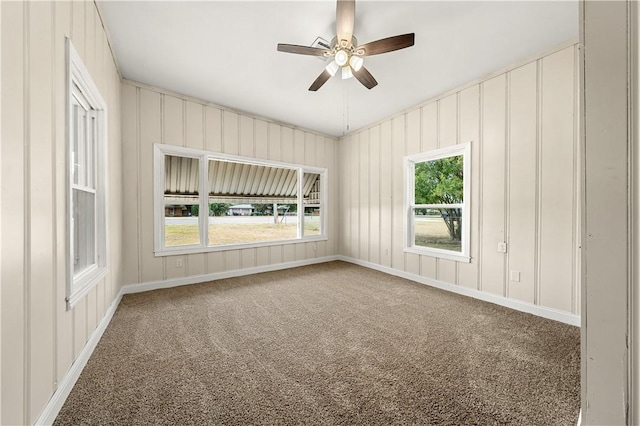 carpeted spare room with ceiling fan