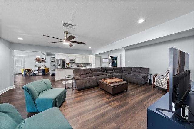 living area featuring visible vents, dark wood-type flooring, and recessed lighting