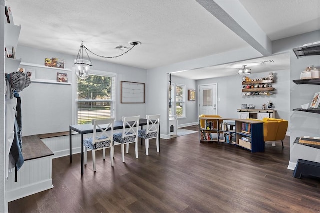 dining space featuring a chandelier, visible vents, baseboards, and wood finished floors