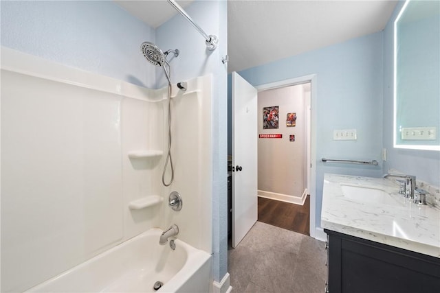 full bath with shower / tub combination, vanity, and baseboards