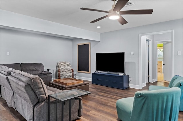 living area with ceiling fan, baseboards, and wood finished floors