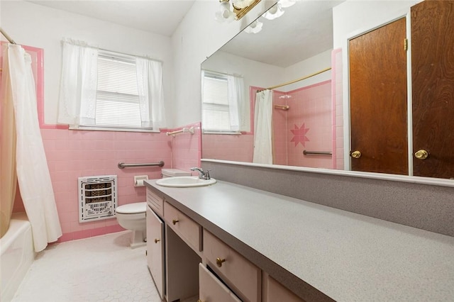 full bathroom with tile patterned floors, vanity, heating unit, tile walls, and toilet