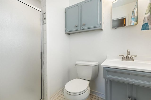 bathroom with vanity, an enclosed shower, and toilet