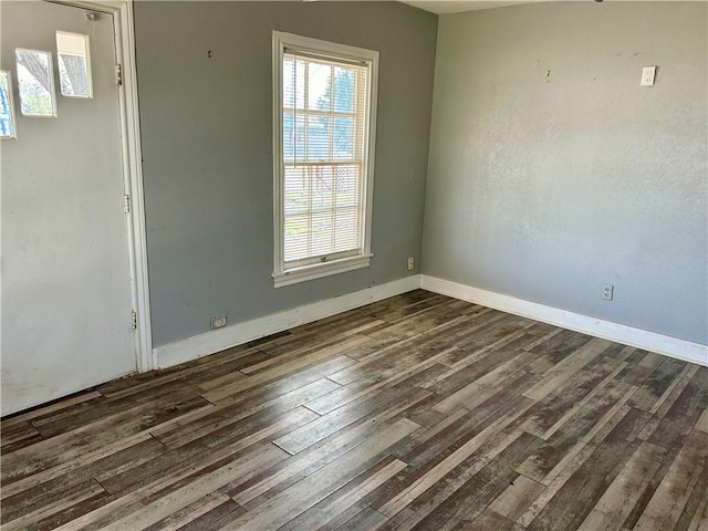 spare room featuring dark hardwood / wood-style floors