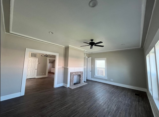 unfurnished living room featuring ceiling fan, crown molding, dark wood-type flooring, and a brick fireplace